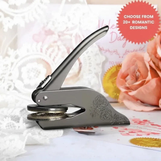 Silver romance themed custom book embosser tool displayed with a soft pink floral background.